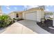 Front view of a single story house with a driveway and garage at 2840 Leicester Ter, The Villages, FL 32162