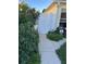 Landscaped garden path with white gate at 2840 Leicester Ter, The Villages, FL 32162