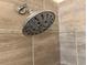 Close-up of a modern shower head in a tiled shower stall at 2840 Leicester Ter, The Villages, FL 32162