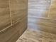 A shower with beige tiles on the walls and smaller tiles on the floor at 2840 Leicester Ter, The Villages, FL 32162