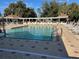 Relaxing community pool with plenty of lounge chairs at 2840 Leicester Ter, The Villages, FL 32162