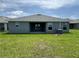 Backyard featuring a covered patio and lush green lawn at 4445 Sw 90Th Pl, Ocala, FL 34476