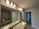 Bathroom with a double sink vanity, white walls and a shower and tub at 4445 Sw 90Th Pl, Ocala, FL 34476