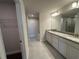 Bathroom featuring a dual-sink vanity, and linen closet at 4445 Sw 90Th Pl, Ocala, FL 34476