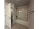 Bathroom featuring a tub and shower with gray tile flooring at 4445 Sw 90Th Pl, Ocala, FL 34476