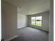 This bedroom has carpet floors and natural light from the window at 4445 Sw 90Th Pl, Ocala, FL 34476