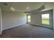 Spacious bedroom boasting tray ceilings and bright windows overlooking a field at 4445 Sw 90Th Pl, Ocala, FL 34476