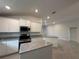 Modern kitchen boasting granite counters, stainless appliances, and white cabinetry in an open layout at 4445 Sw 90Th Pl, Ocala, FL 34476