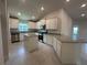 Bright kitchen showcasing white cabinets, granite counters, a center island, and stainless appliances at 4445 Sw 90Th Pl, Ocala, FL 34476