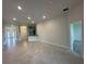 Bright, open-concept living room featuring recessed lighting and neutral tile floors at 4445 Sw 90Th Pl, Ocala, FL 34476