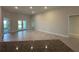 Spacious living room featuring neutral walls, tile flooring and double doors to the backyard at 4445 Sw 90Th Pl, Ocala, FL 34476