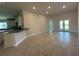 Open-concept living room with granite countertops, stainless steel appliances, and tile flooring at 4445 Sw 90Th Pl, Ocala, FL 34476