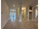 Spacious living area featuring tile floors, columns, and an open layout with ample natural light at 4445 Sw 90Th Pl, Ocala, FL 34476