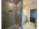Modern bathroom featuring an enclosed tile shower, granite vanity, and bright lighting at 4477 Sw 90Th Pl, Ocala, FL 34476