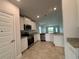 Modern kitchen with stainless steel appliances, granite countertops, white cabinetry and tile flooring at 4477 Sw 90Th Pl, Ocala, FL 34476