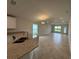 Bright living room with tile flooring, large windows for natural light, and view to a modern kitchen at 4477 Sw 90Th Pl, Ocala, FL 34476