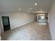 Spacious living room with tile floors, recessed lighting and an open concept to the modern kitchen at 4477 Sw 90Th Pl, Ocala, FL 34476