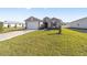 Newly built home with a large driveway and grassy lawn at 7772 Sw 56Th Pl, Ocala, FL 34474