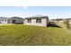 Back of house with sliding glass doors and grassy yard at 7772 Sw 56Th Pl, Ocala, FL 34474