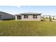 Back of house with sliding glass doors and grassy yard at 7772 Sw 56Th Pl, Ocala, FL 34474