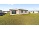 Back of house with sliding glass doors and grassy yard at 7772 Sw 56Th Pl, Ocala, FL 34474