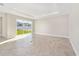 Spacious living room featuring tile floors and sliding glass doors at 7772 Sw 56Th Pl, Ocala, FL 34474