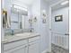 Bright bathroom with white vanity, granite countertop, framed mirror, and neutral paint color at 816 Hibiscus Dr, The Villages, FL 32159