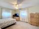 Spacious bedroom with wood dresser and large TV at 8955 Sw 104Th Pl, Ocala, FL 34481