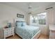 Bright bedroom with a coastal theme, white furniture, and a large window with natural light at 9257 Sw 94Th Loop, Ocala, FL 34481