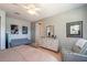 Bright bedroom features a ceiling fan, gray walls, and decorative art pieces at 9257 Sw 94Th Loop, Ocala, FL 34481