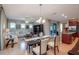 Bright dining room features a glass table and chairs, adjacent to the kitchen and living areas at 9257 Sw 94Th Loop, Ocala, FL 34481