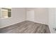 Well-lit bedroom with wood-look floors and sliding door closet at 10218 Sw 99Th Ln, Ocala, FL 34481