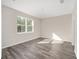 Bright bedroom with neutral walls and wood-look flooring at 10218 Sw 99Th Ln, Ocala, FL 34481