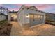 Craftsman style home with gray garage door and paver driveway at 10218 Sw 99Th Ln, Ocala, FL 34481