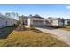 Single-story house with gray garage door and landscaped yard at 10218 Sw 99Th Ln, Ocala, FL 34481