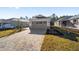 Single story home with gray garage door and paver driveway at 10218 Sw 99Th Ln, Ocala, FL 34481