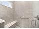 Walk-in shower with built-in seat and neutral tile at 10282 Sw 99Th Ln, Ocala, FL 34481