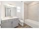 Bathroom with gray vanity, tub, and tile surround at 10832 Sw 101St Loop, Ocala, FL 34481