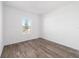 Well-lit bedroom featuring wood-look flooring and a window at 10832 Sw 101St Loop, Ocala, FL 34481