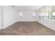 Bright living room with wood-look floors and large windows at 10832 Sw 101St Loop, Ocala, FL 34481