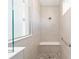 Large walk-in shower with built-in seat and pebble flooring at 10832 Sw 101St Loop, Ocala, FL 34481