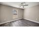 Simple bedroom with wood-look flooring and large window at 14366 Se 27Th Ct, Summerfield, FL 34491