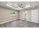 Main bedroom with ceiling fan, en-suite bathroom and walk-in closet at 14366 Se 27Th Ct, Summerfield, FL 34491