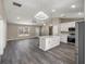 Modern kitchen boasts white cabinets, stainless steel appliances and an island at 14366 Se 27Th Ct, Summerfield, FL 34491