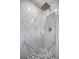 Modern shower with marble tile and a rainfall shower head at 14366 Se 27Th Ct, Summerfield, FL 34491