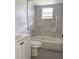 Bathroom featuring tiled walls, a bathtub-shower combination, and a white vanity at 21111 Se Honeysuckle St, Dunnellon, FL 34431