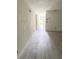 Bright hallway features new wood-look flooring and neutral paint, offering a clean, modern aesthetic at 21111 Se Honeysuckle St, Dunnellon, FL 34431