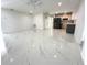 A spacious living room with tile flooring that leads to a contemporary kitchen at 21111 Se Honeysuckle St, Dunnellon, FL 34431