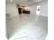 Bright and airy living room with modern tile floors, open to a stylish kitchen area at 21111 Se Honeysuckle St, Dunnellon, FL 34431