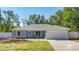 Newly constructed home with light blue exterior, white fence, and attached garage at 28 Pecan Run, Ocala, FL 34472